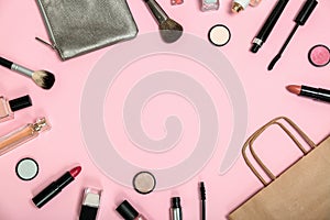 Flat lay composition with shopping bag and cosmetics