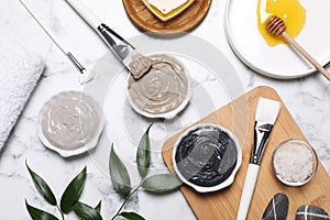 Flat lay composition with spa products for masks on white marble table
