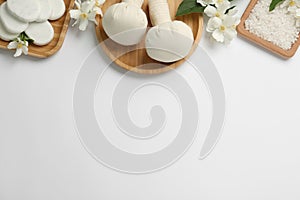 Flat lay composition with spa stones and beautiful jasmine flowers on white background, space for text