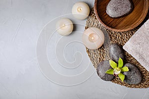 Flat lay composition with spa stones and burning candles on table, space for text