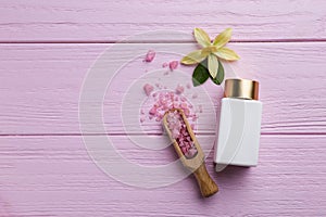 Flat lay composition with spa supplies on pink wooden table