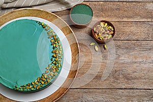 Flat lay composition with spirulina cheesecake on wooden table