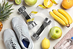 Flat lay composition with sport items and healthy food on grey background