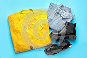 Flat lay composition with stylish boots on light blue background