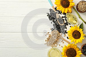 Flat lay composition with sunflower oil on white wooden table, space for text