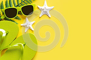 Flat lay composition with sunglasses, starfish, seashells and beach flip flops with copy space for text. Summer vacation concept