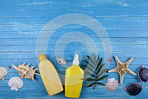Flat lay composition with sunscreen and seashells