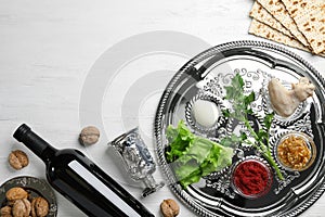 Flat lay composition with symbolic Passover Pesach items and meal on wooden background