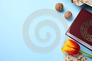 Flat lay composition with symbolic Pesach Passover Seder items on light blue background, space for text