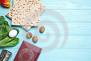 Flat lay composition with symbolic Pesach Passover Seder items on blue wooden table, space for text