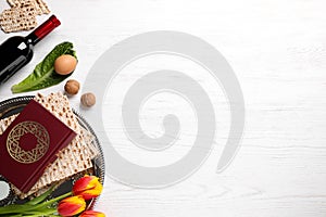 Flat lay composition with symbolic Pesach Passover Seder items on wooden table, space for text