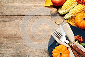 Flat lay composition with tableware, autumn fruits and vegetables on wooden background, space for text. Thanksgiving Day