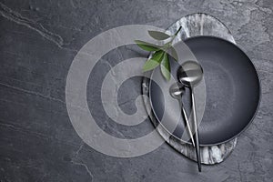 Flat lay composition with tableware on black background. Space for text