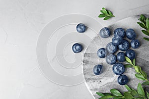 Flat lay composition with tasty blueberries on  table, space for text