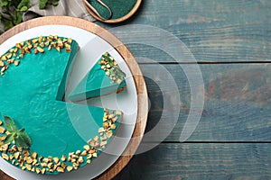 Flat lay composition with tasty  cheesecake on blue wooden table, space for text