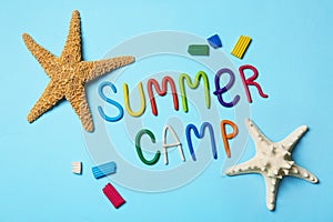 Flat lay composition with text SUMMER CAMP made of modelling clay