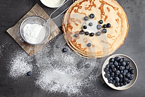 Flat lay composition with thin pancakes and berries