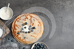 Flat lay composition with thin pancakes and berries