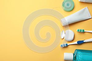 Flat lay composition with toothpaste, oral hygiene products and space for text