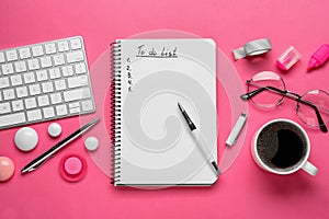 Flat lay composition with unfilled To Do list, computer keyboard and cup of coffee on pink background