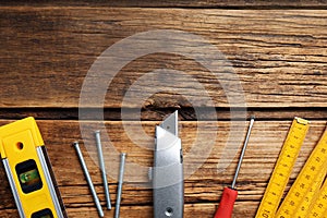 Flat lay composition with utility knife and different tools on table. Space for text