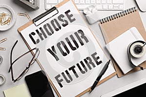 Flat lay composition with words CHOOSE YOUR FUTURE, computer keyboard and stationery on table. Career concept