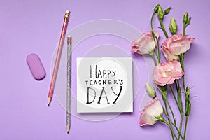 Flat lay composition with words HAPPY TEACHER`S DAY, stationery and flowers on background