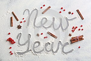 Flat lay composition with words New Year made of flour on grey table, flat lay