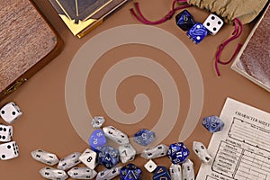 Flat lay concept design for tabletop role playing with colorful blue and white RPG dices, character sheet and rule books