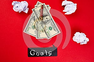 Flat lay of concept of search idea, goals, Magnifying glass, money dollars banknote