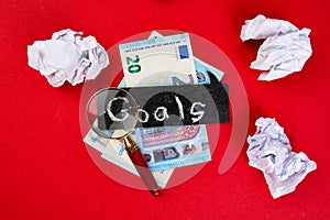 Flat lay of concept of search idea, goals, Magnifying glass, money euro banknote