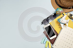 Flat lay concept of travel accessories vacation trip and long summer weekend planning on blue table with blank space for text