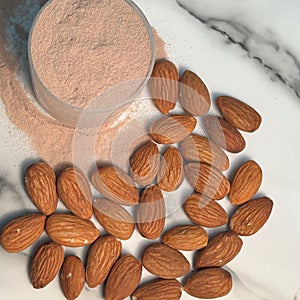 Flat lay conceptual image of protien powder and almonds