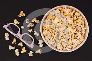 Flat lay. Copyspace. Cinema Concept. Background. Popcorn, cup and 3d glasses on a dark background. Focus on 3D glasses