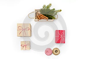 Flat lay craft boxes, white and red rope and box cinnamon and pine tree on white