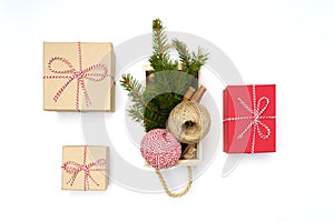 Flat lay craft boxes, white and red rope and box cinnamon and pine tree on white
