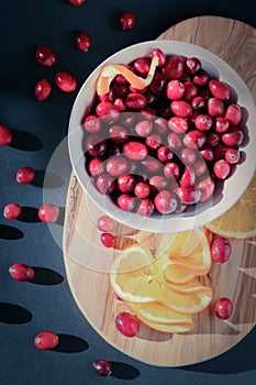 Flat lay of cranberries and juicy orange slices