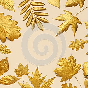 Flat lay creative autumn composition. Frame from Golden leaves on beige background top view copy space. Fall concept. Autumn