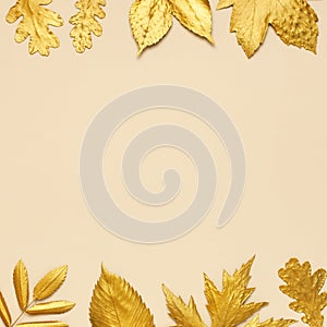 Flat lay creative autumn composition. Frame from Golden leaves on beige background top view copy space. Fall concept. Autumn