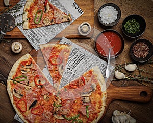 Flat lay of a delicious Italian pizza, sauce, spices on a table