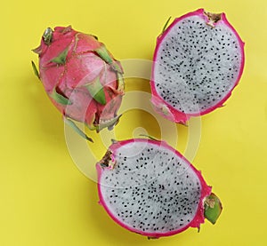 Flat lay delicious and sweet cut in half of Dragon fruits isolated on a bright yellow background background