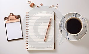 Flat lay desk with notebook, clipboard, coffee cup and pen, rose gold accessories