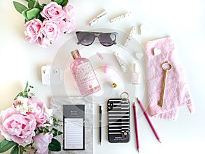 Flat lay with different accessories. Pink, rose, white, black.