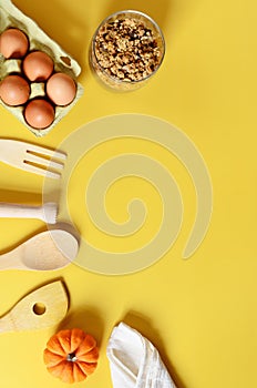 Flat lay with different kitchen and cooking utensils on yellow background. Culinary blog, recipe template, online cooking courses.