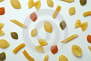 Flat lay with different uncooked pasta on white background