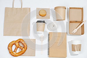 Flat lay eco friendly composition. Carton compostable products over white