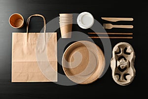 Flat lay with eco - friendly tableware on black background