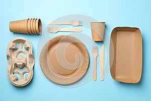 Flat lay with eco - friendly tableware on blue background