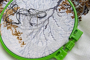 Flat lay embroidery Hoop with canvas and bright sewing thread and embroidery needle