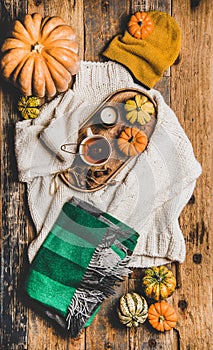 Flat-lay of fall trendy women apparel layout over rustic background